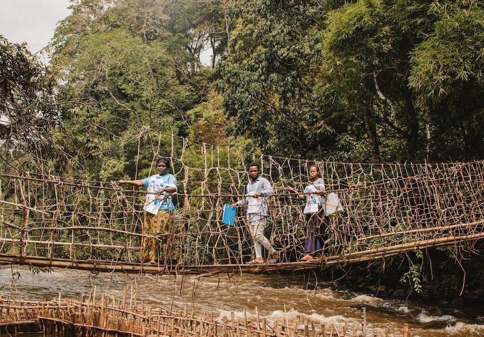 A UNICEF-supported vaccination team crosses the Ulindi bridge over the Ulindi River in South Kivu province, DR Congo, to vaccinate children against polio on August 14, 2023.