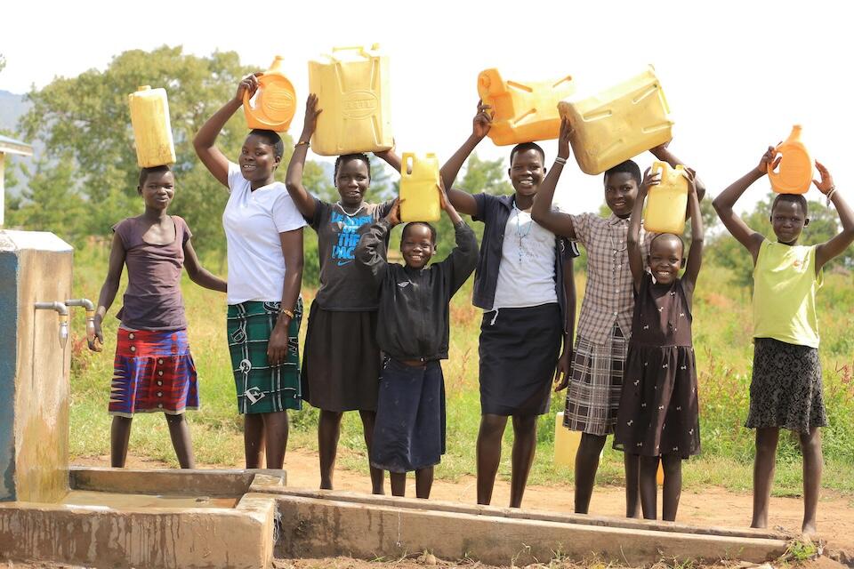 A group of girls hold jerry cans by a UNICEF-supported water collection point in Lodwari village, in Lobalangit sub-county, Karenga district, Uganda.