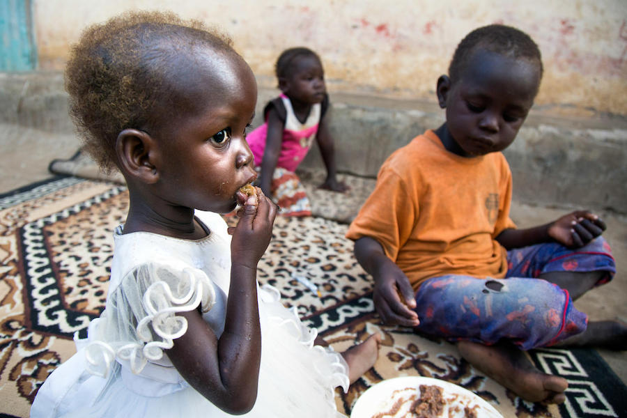Maria, 2, and her brother Chris, 5, eat dinner at their family's home in Juba, South Sudan. Maria was treated for severe acute malnutrition at a UNICEF-supported health center in October 2017.