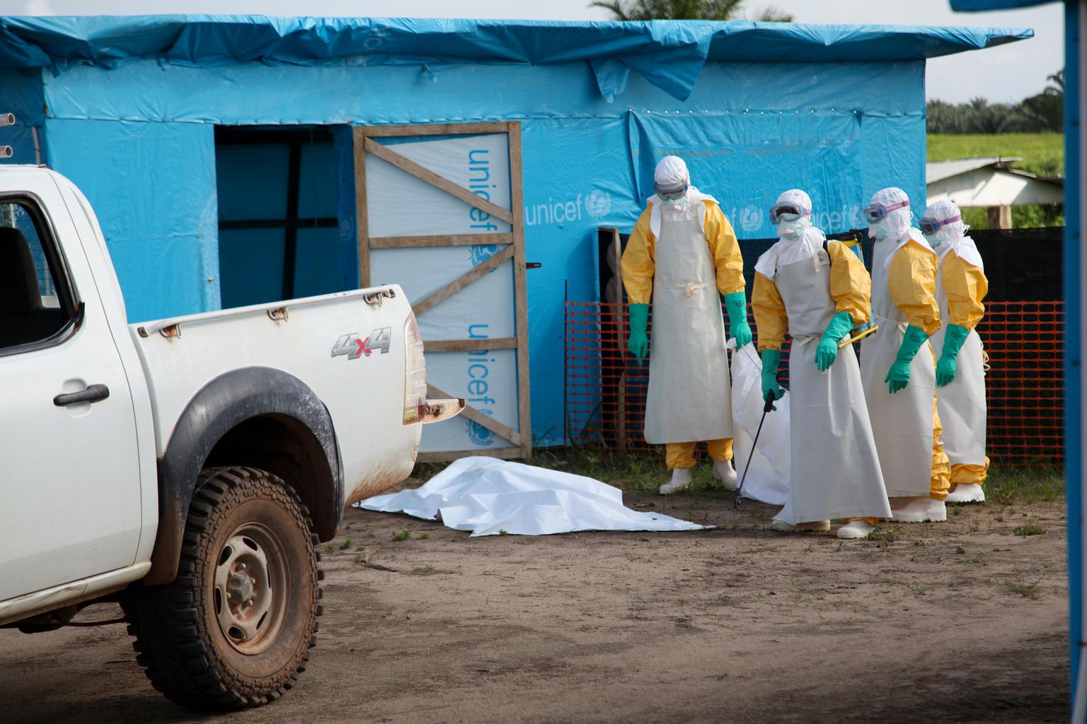 In July 2014 in Liberia, health workers, wearing head-to-toe protective gear, prepare for work, outside an isolation unit in Foya District, Lofa County. 