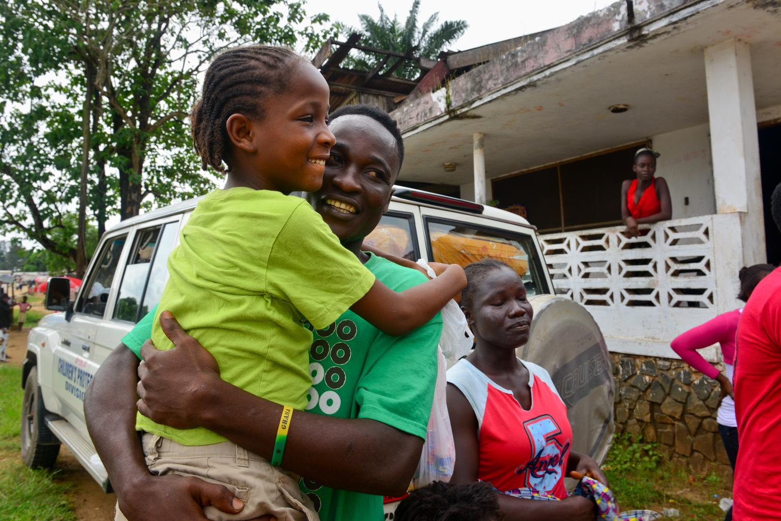Nine-year-old Mercy, an Ebola orphan in Monrovia, Liberia, is reunited with her older brother outside a UNICEF-supported interim care center.