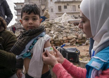 On Feb. 10, 2023, Hamzeh, 4, is screened for malnutrition by Hiba, a UNICEF-supported mobile health team leader,  in the Alsalheen neighborhood of the city of Aleppo, northern Syria. 
