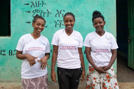 Three members of the gender club at Anka Primary School in SNNP region, Ethiopia, wear T-shirts that read, "Women's menstruation is not a curse but rather a natural gift."