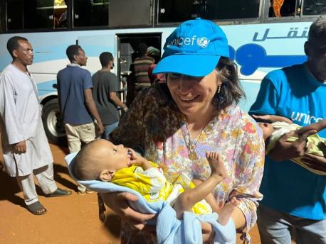 In Madani, Sudan, UNICEF Emergency Manager Narine Aslanyan holds one of the babies who had just been successfully evacuated from the Mygoma orphanage in Khartoum.