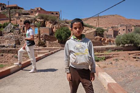 On Sept. 10, 2023, Marwan, 9, stands in front of his village, Azro, near Tahanaout in the Atlas Mountains of Morocco, two days after it was destroyed by a massive earthquake.