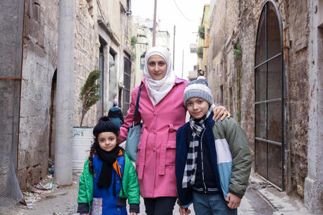 Sara, 5, and Waed, 12, with their mother Bushra outside a UNICEF-supported child protection center in Maysalun neighbourhood, Aleppo city, Syria, on Feb. 8, 2024.