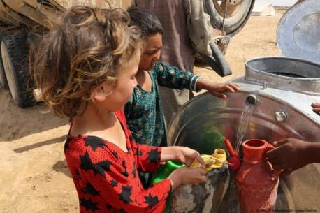 Children Fill Up Bottles With Safe Water