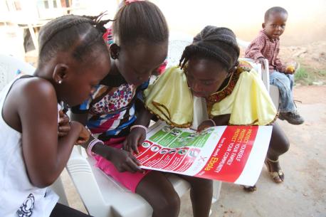 Children Gather Around UNICEF Ebola Infographic