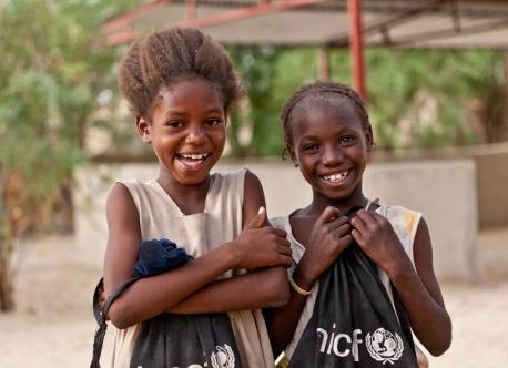 Here, Aïssata Fondo (10) on the left and Maïmouna Cissé (10) on the right are pictured with their UNICEF school bags at the Alpha Moya school in Timbuctu, Mali 2013