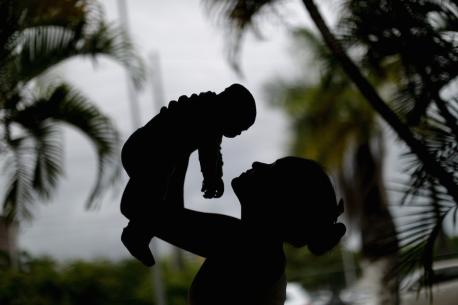 Woman Holding Child in the Air