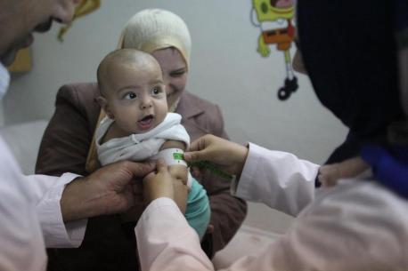 Rudania, a mother of 3, takes her 7-month-old daughter to a nutrition center in Damascus, Syria, where her mid-upper arm circumference is measured to assess her nutritional status.
