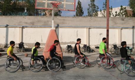 On 22 November 2019, adolescent boys use wheelchairs in an outdoor basketball court at Abdul Ahad Karzai Orphanage in Kandahar, Afghanistan. Many of them have been injured in conflict and have lost limbs in landmine accidents.