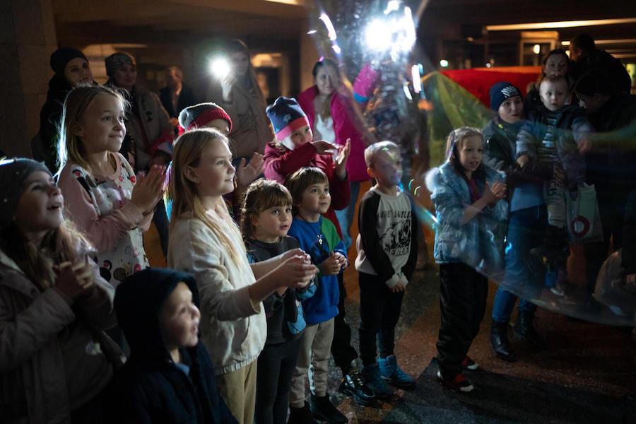 Children watch a magician perform at a UNICEF-supported Spilno center at a metro station in Kharkiv, Ukraine.