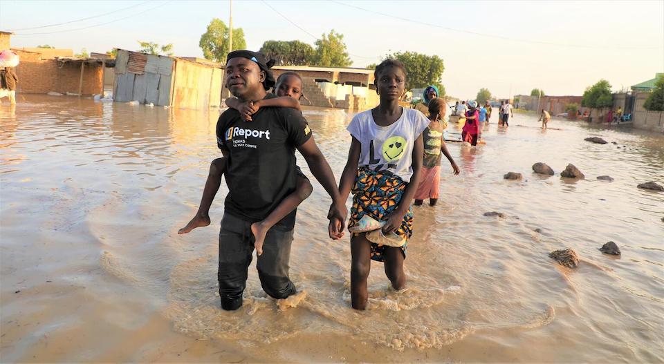 On Oct. 15, 2022, a U-Reporter in N'Djamena, Chad, helps a family to safety in an area affected by flooding, the result of the heaviest rainy season in 30 years. 