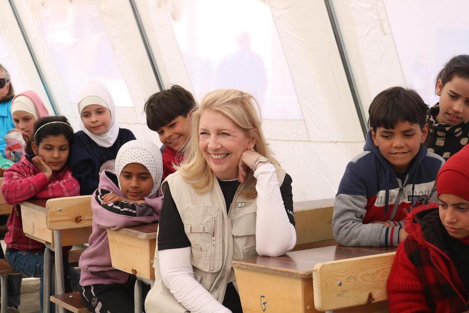 On March 1, 2023, in in Aleppo, Syria, UNICEF Executive Director Catherine Russell sits with children in a school being used as a temporary collective shelter for children and families affected by the Feb. 6 earthquakes.