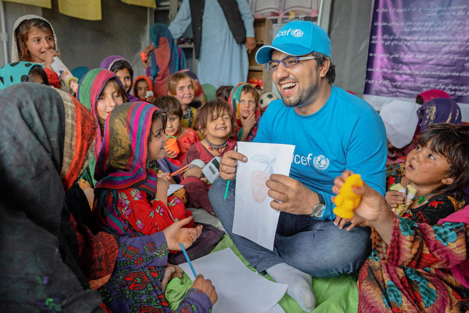 On July 17, 2022, UNICEF Education Specialist Bahir Wyaar plays with earthquake survivors at a UNICEF-supported Child Friendly Space in Gayan District, Paktika Province, Afghanistan.