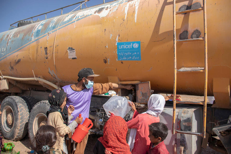 On Oct. 10, 2023, residents of Zinda Jan district gather at the UNICEF truck to collect clean, safe water for drinking, bathing, cooking and more. 
