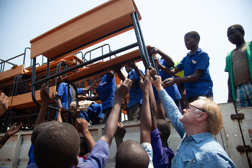 MSNBC's Lawrence O'Donnell, far right, helped students unload new desks from the K.I.N.D. Fund in Phalombe District, Malawi, in October 2023.