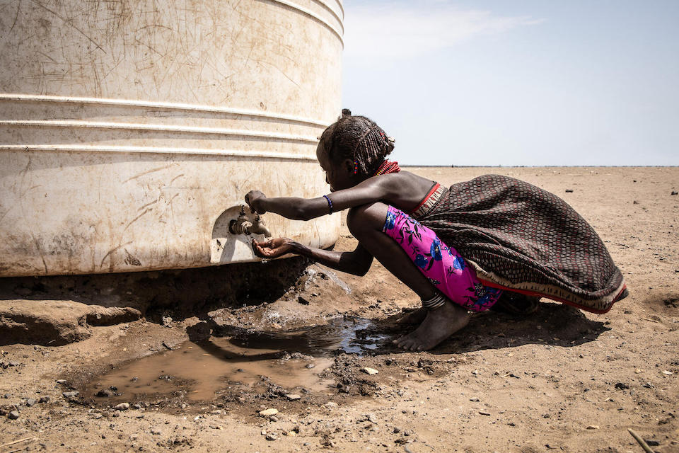 In the Libemuket district of southern Ethiopia, a young girl pulls water from a water tank provided by UNICEF as part of an emergency drought response.