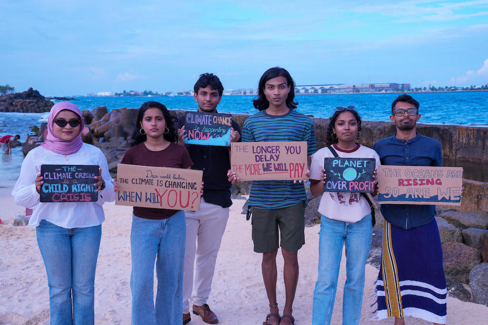 Six youth participants in a mock negotiating session organized by UNICEF in the lead up to a youth climate conference stand on an artificial beach in Malé, Maldives. Youth agency and participation in climate solutions are considered critical in the country’s fight against climate change. 