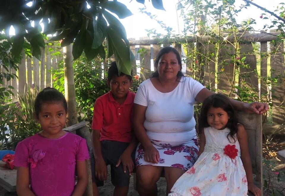 Elizabeth, who migrated from Honduras to Belize at age 19, is able to support her three children with cash assistance from UNICEF.