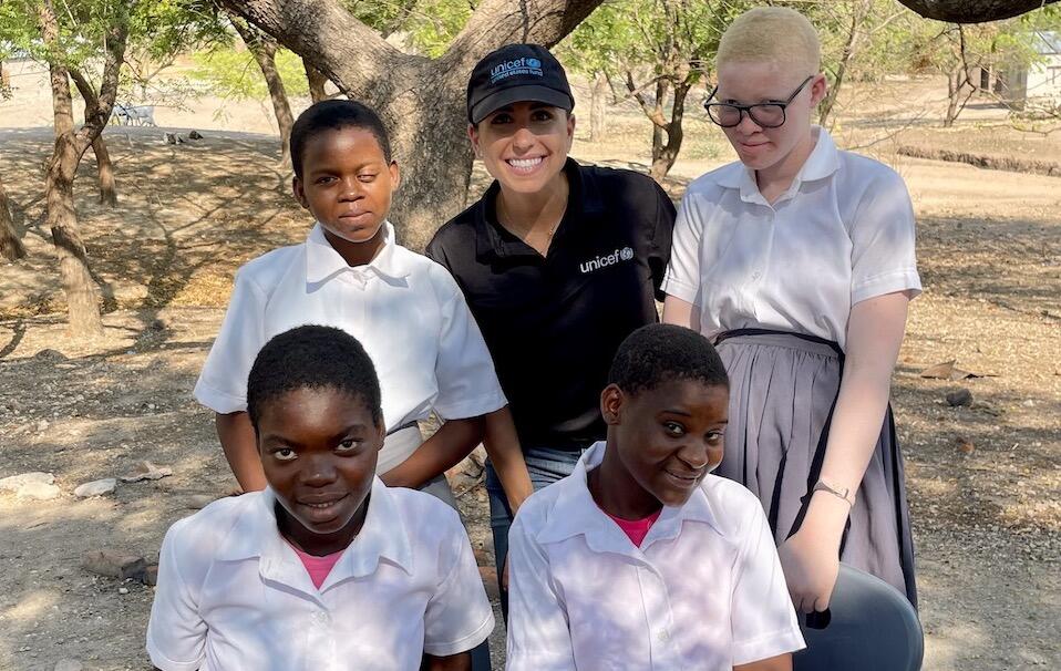 Students from Ngabu Secondary School in Chikwawa District, southern Malawi, with UNICEF USA's Nina Marie Costa, in black, in October 2023. 