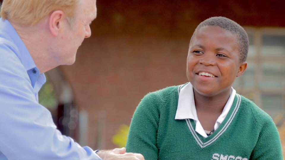 Joyce Chisele meets with MSNBC's Lawrence O'Donnell in 2016, the year she received a scholarship through the UNICEF-supported K.I.N.D. Fund helping girls in Malawi attend secondary school.