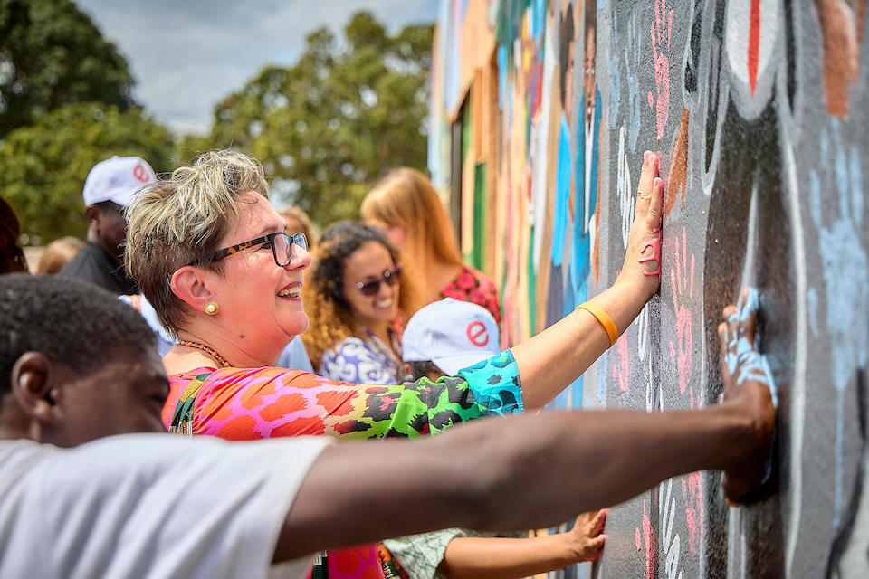 Zonta International President Ute Scholz joins community members to paint a mural in Monapo District, Nampula Province, Mozambique on Sept. 21, 2023. 