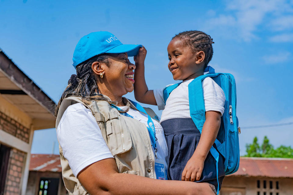 On Oct. 12, 2023, 7-year-old Nkembo is held by UNICEF staff member Solange Nabintu Murhega, Knowledge Management Officer in Kinshasa, DRC.