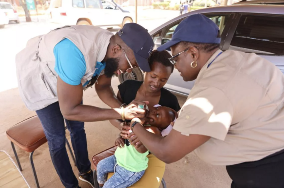 Dr Alex Adjagba, Chief of Health and Nutrition and Health Specialist Egnes Makwabarara administering a polio vaccination at the Hatcliff Family Health Services Clinic in Zimbabwe.