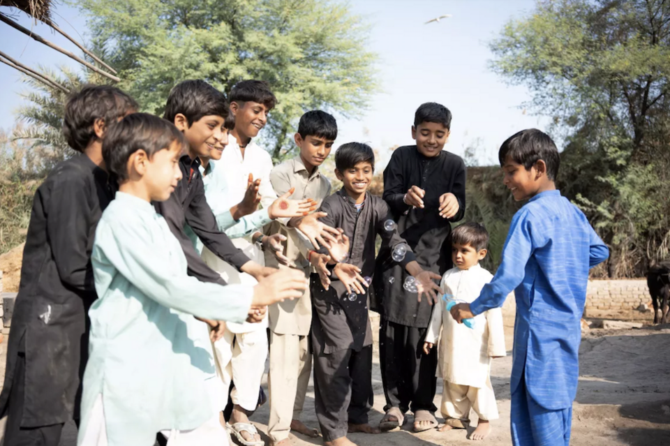 Seven-year-old Ehsan, far right, plays with friends in Syed Ibrahim Shah village, Pakistan. 
