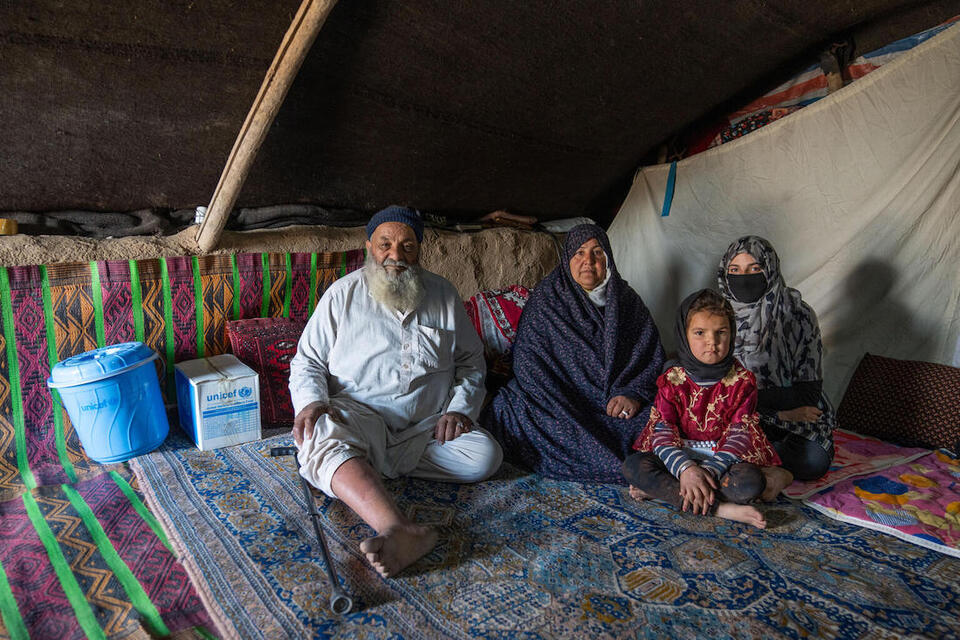 On Jan. 14, 2024, in Zinda Jan district, Afghanistan, a family sits in the tent where they have lived since their home was destroyed by an Oct. 2023 earthquake. 