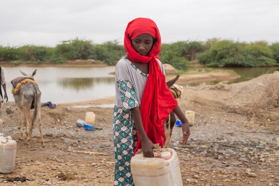 Arafat, 10, of Gelhanty village, Agig locality, Red Sea state, Sudan.with a 16-liter water jug that is typical of what young children must carry to fetch water for their families in water stressed areas of the world.