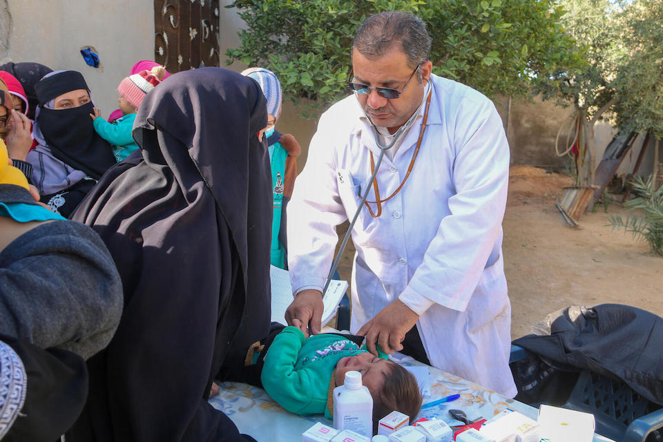 Dr. Mara'e, a pediatrician, examines 1-year-old Mohamad at a UNICEF- supported mobile clinic in Suwaidan Shamiya village, Deir ez- zor governorate, Syria, on Nov. 22, 2023.