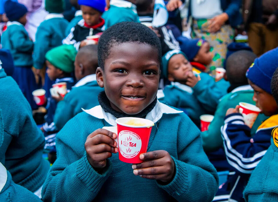 A 5-year-old boy holds a cup of porridge provided as a part of UNICEF campaign to end stunting through nutrition education and related interventions.