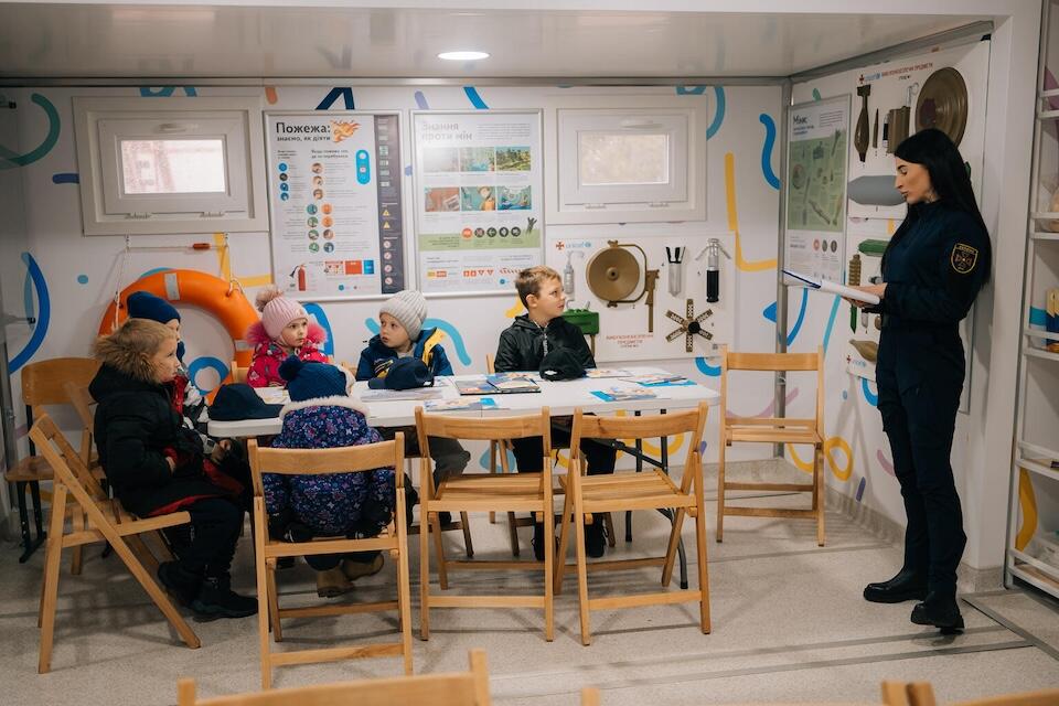 In a mobile classroom donated by UNICEF, specialists from the State Emergency Service of Ukraine and the National Police teach children in the Kharkivska region to follow mine safety rules.
