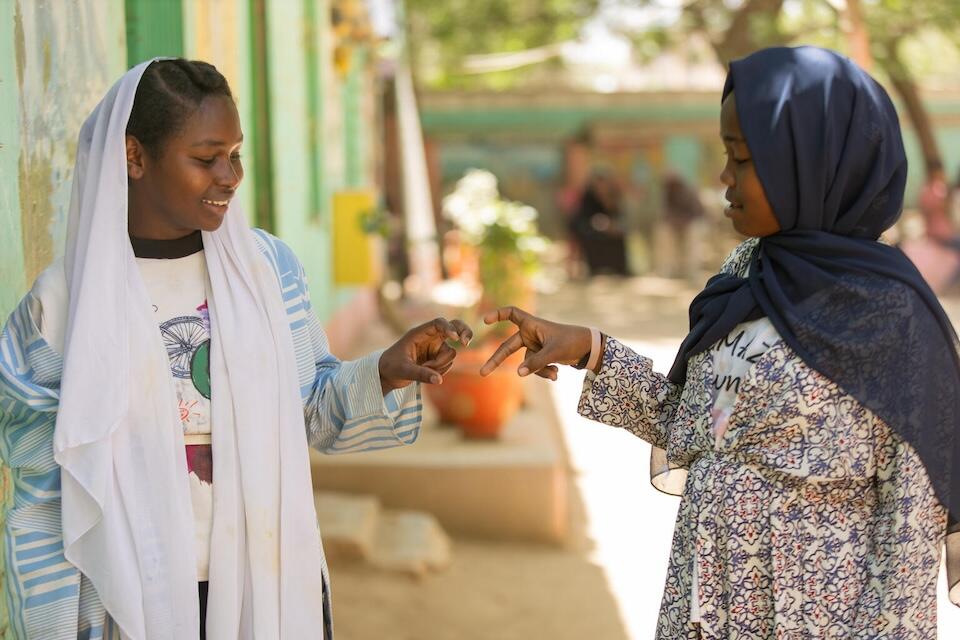 From left: Walaa, 15, with her sister Shegn at the UNICEF-supported Alshargia safe learning space or Makanna in Kassala state, Sudan.