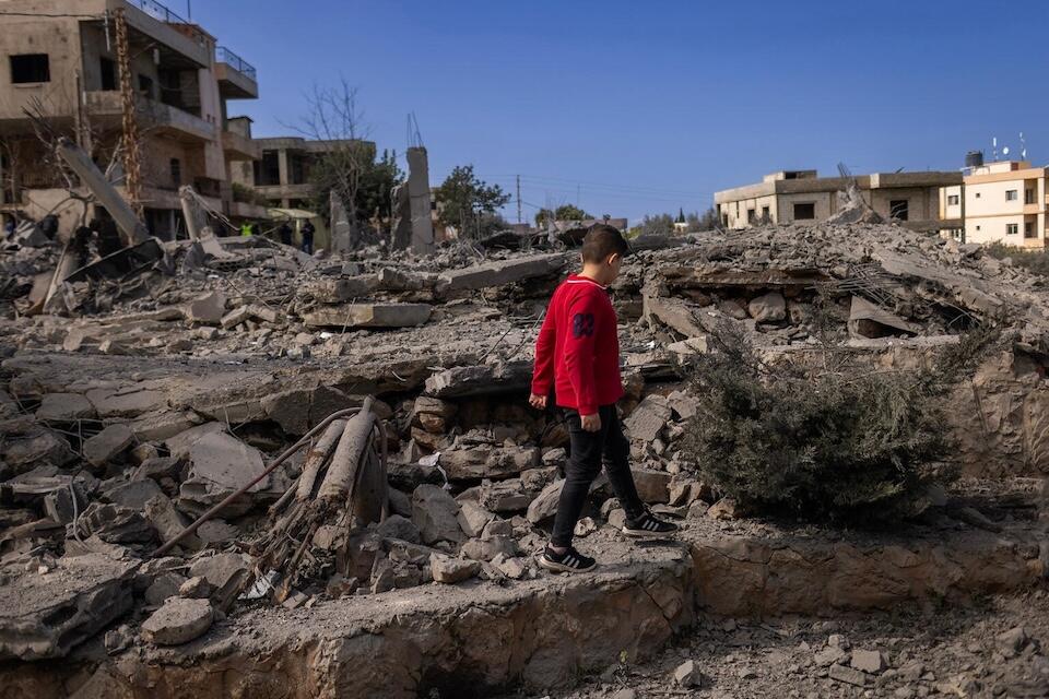 Amal a 5-year-old from Majdal Zoun, walks among the ruins of a house destroyed in southern Lebanon on Feb. 22, 2024. 