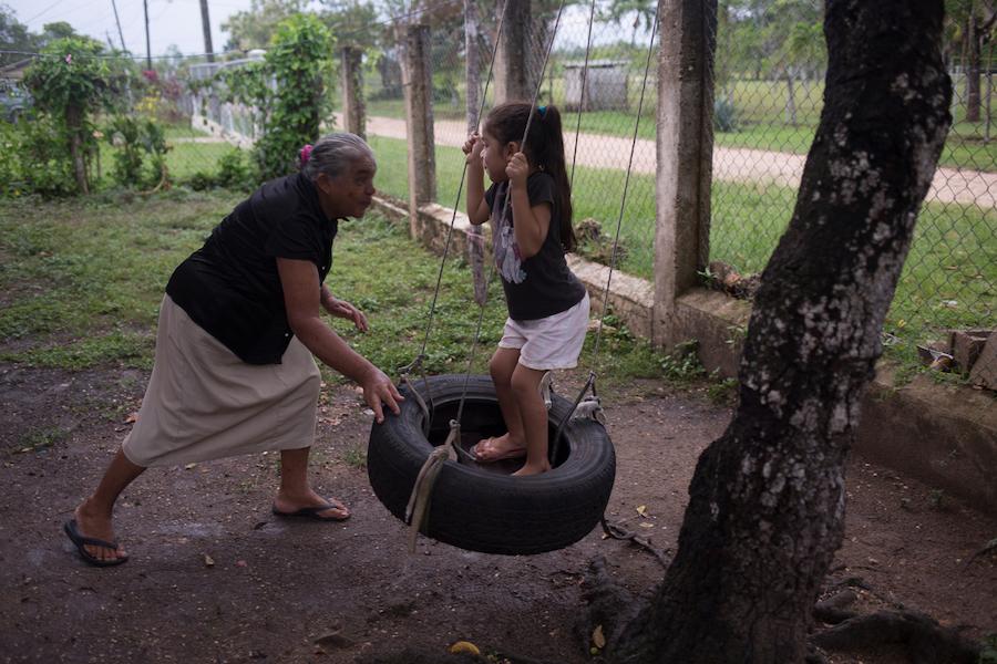 Conzuelo pushes her great-granddaughter Allizon, 4, on a home-made swing in Cayo District, Belize, August 2016. Because Allizon’s mother works full time, Conzuelo is Allizon’s primary caregiver and spends many hours interacting with her every day.