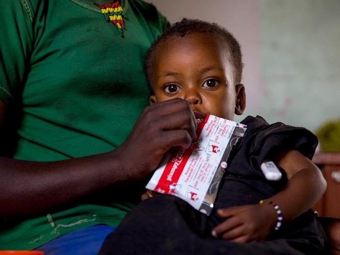 An acutely malnourished child in Ethiopia gets ready-to-use-therapeutic food (RUTF).