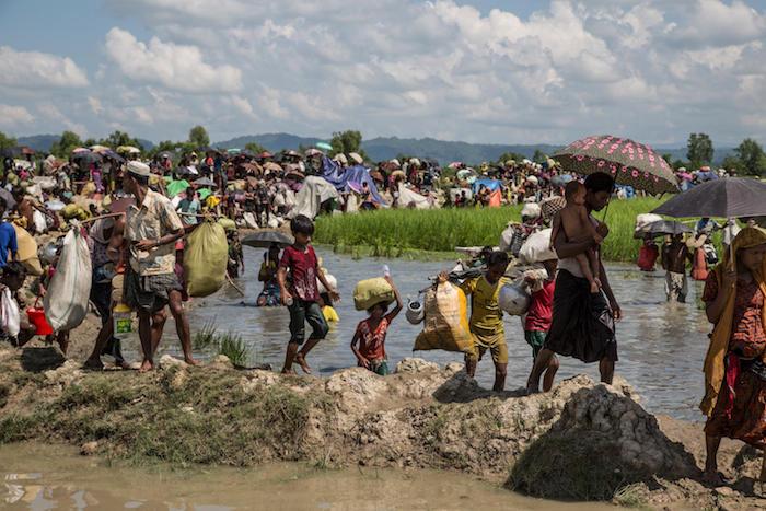 Thousands of Rohingya refugees fleeing Myanmar are stuck on a pedestrian road in the midst of paddy fields two kilometers from the Bangladesh border on October 16, 2017. 