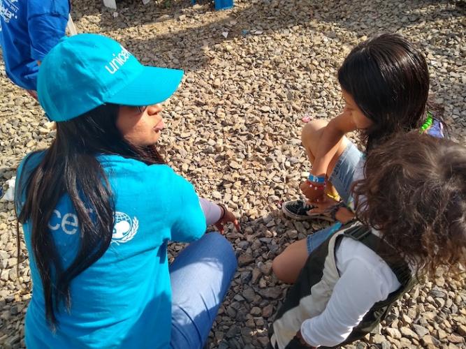 A UNICEF volunteer engages with migrant children from Central America staying at the 'El Barretal' shelter, Tijuana, Baja California state, Mexico. 