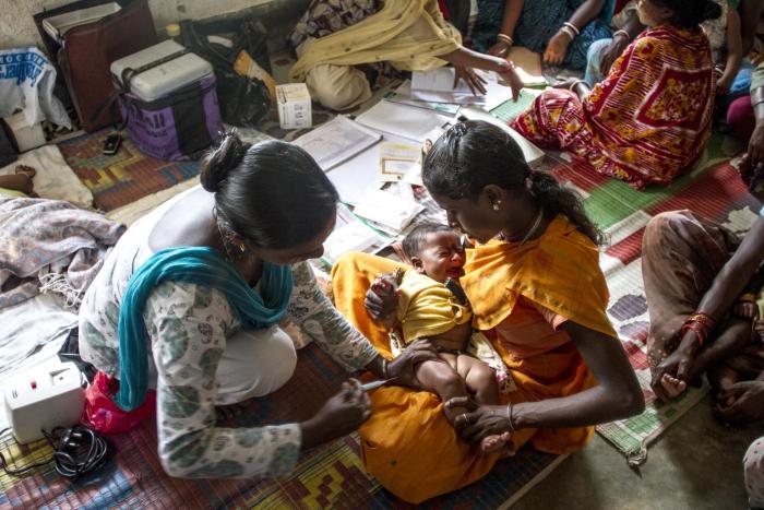 A child is vaccinated against tetanus at a health center in Nmakum, India. 