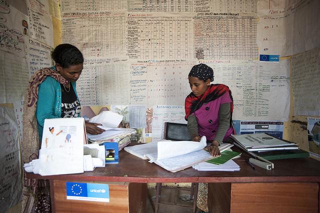 Two health extension workers prepare their monthly report on nutrition activities in their district. ©UNICEF Ethiopia/2014/Tsegaye.