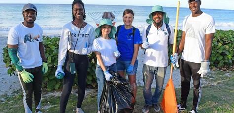 UNICEF Youth Advocate Maria, center, with fellow climate activists, led an environmental clean-up in Oistins, a fishing town in Barbados, in March 2024. 
