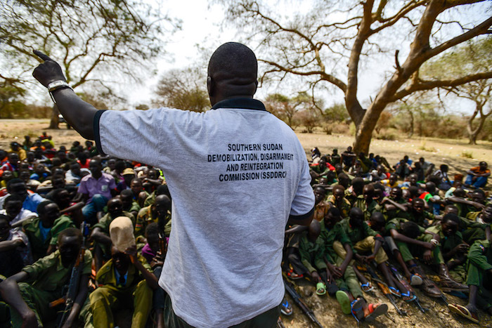 A worker from the South Sudan National Disarmament, Demobilization and Reintegration Commission addresses children undergoing release from an armed group, in Pibor, South Sudan, in February 2015.