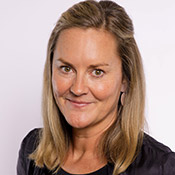 bust portrait of Katie Behncken, a woman with blonde hair draped over her shoulders, wearing a black jacket