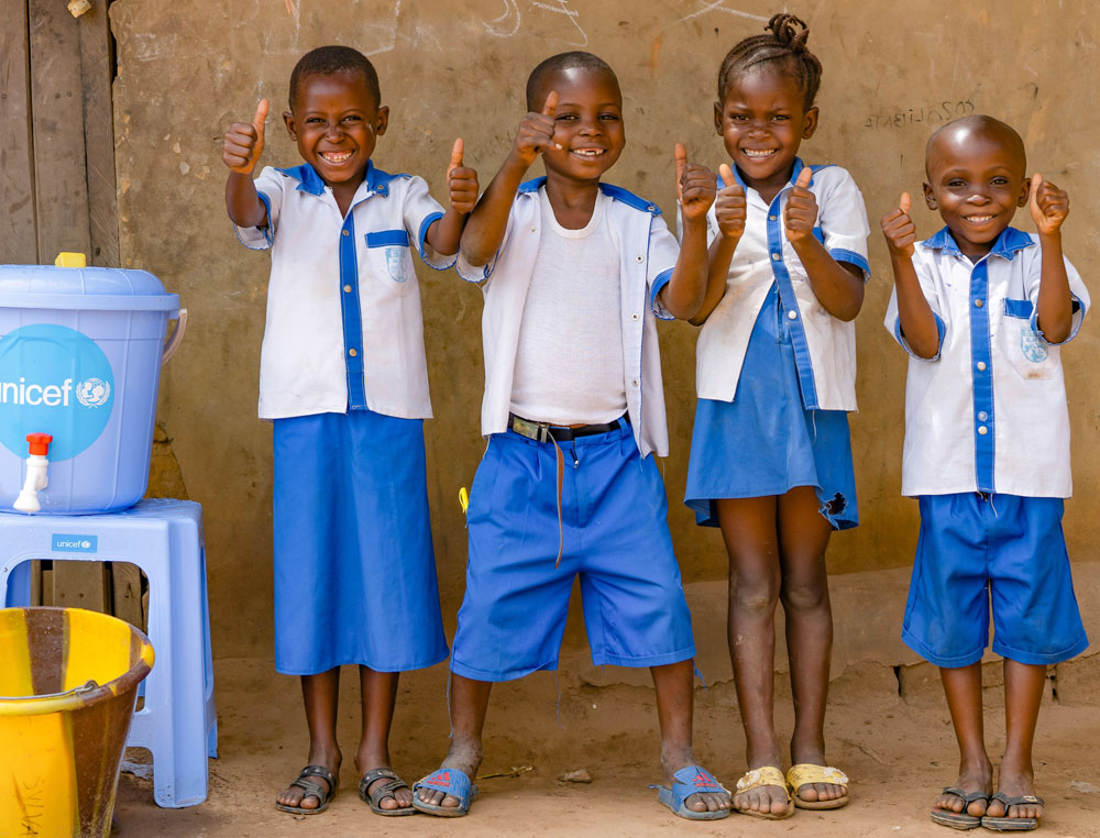 Students at Ecole Primaire Ilako in Mbandaka, DR Congo, stand outside their classroom after washing their hands. UNICEF has installed handwashing stations at the school to help students protect themselves from Ebola.