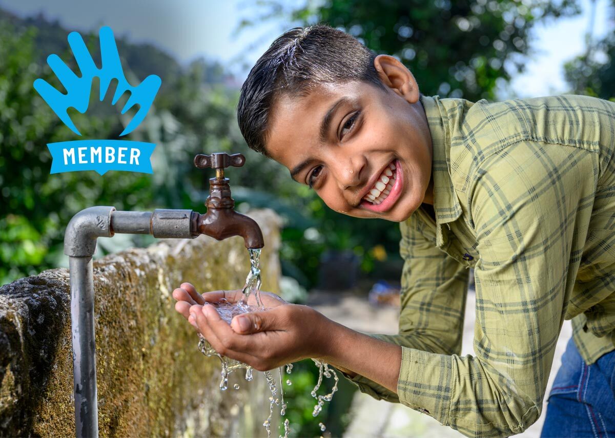 Happy child drinking water from tapped water connection provided to his village house by JJM. Location : Village Bathol, Solan, Himachal Pradesh, India