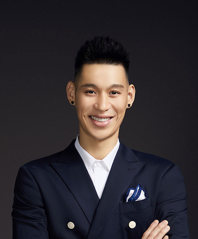 Profile of Jeremy Lin smiling in a suit with arms crossed.